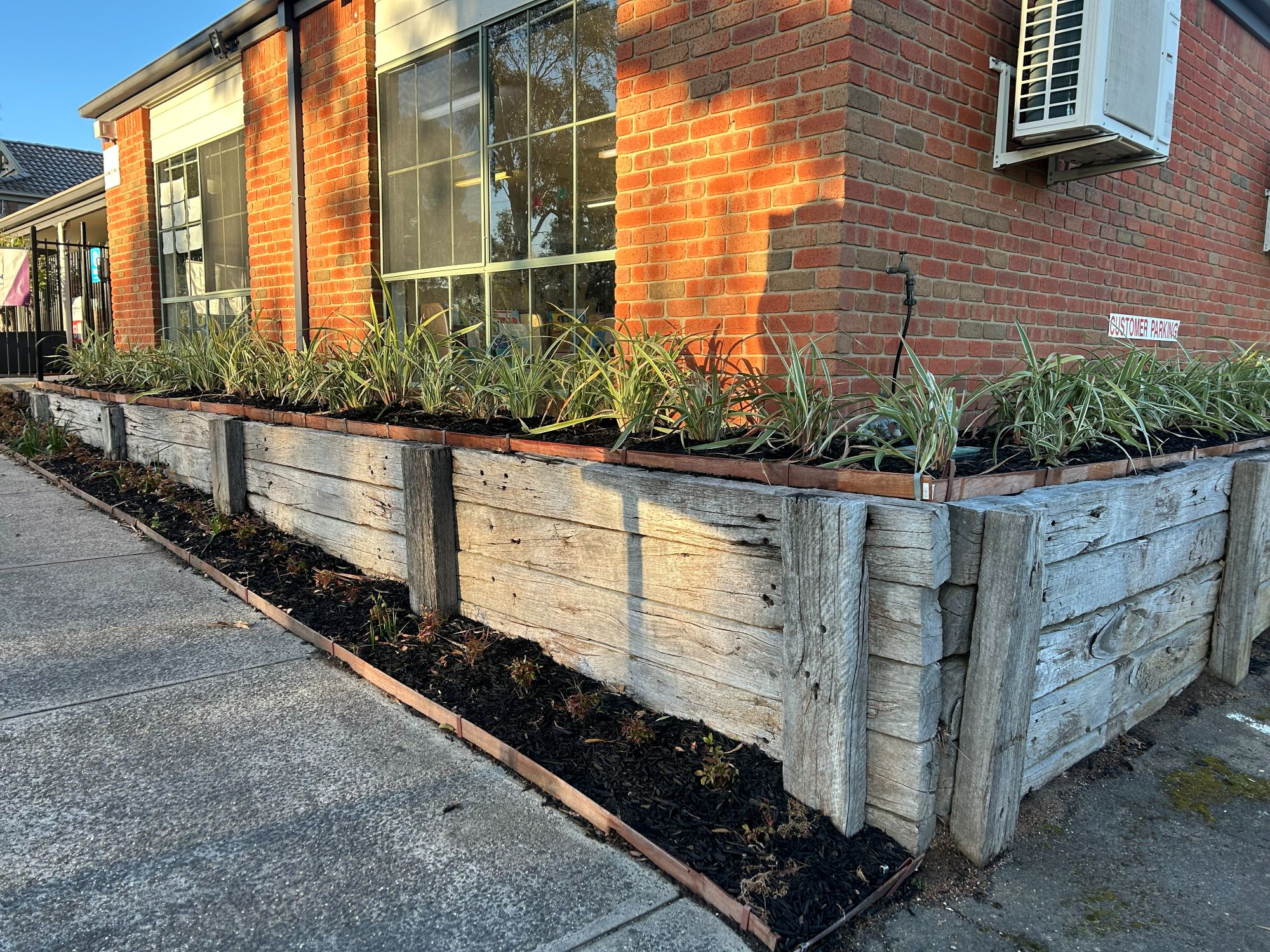 Before — Commercial Curb Appeal: Modernizing Tired Retaining Walls